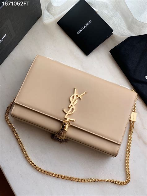 beige clutch ysl|YSL clutch bag with tassel.